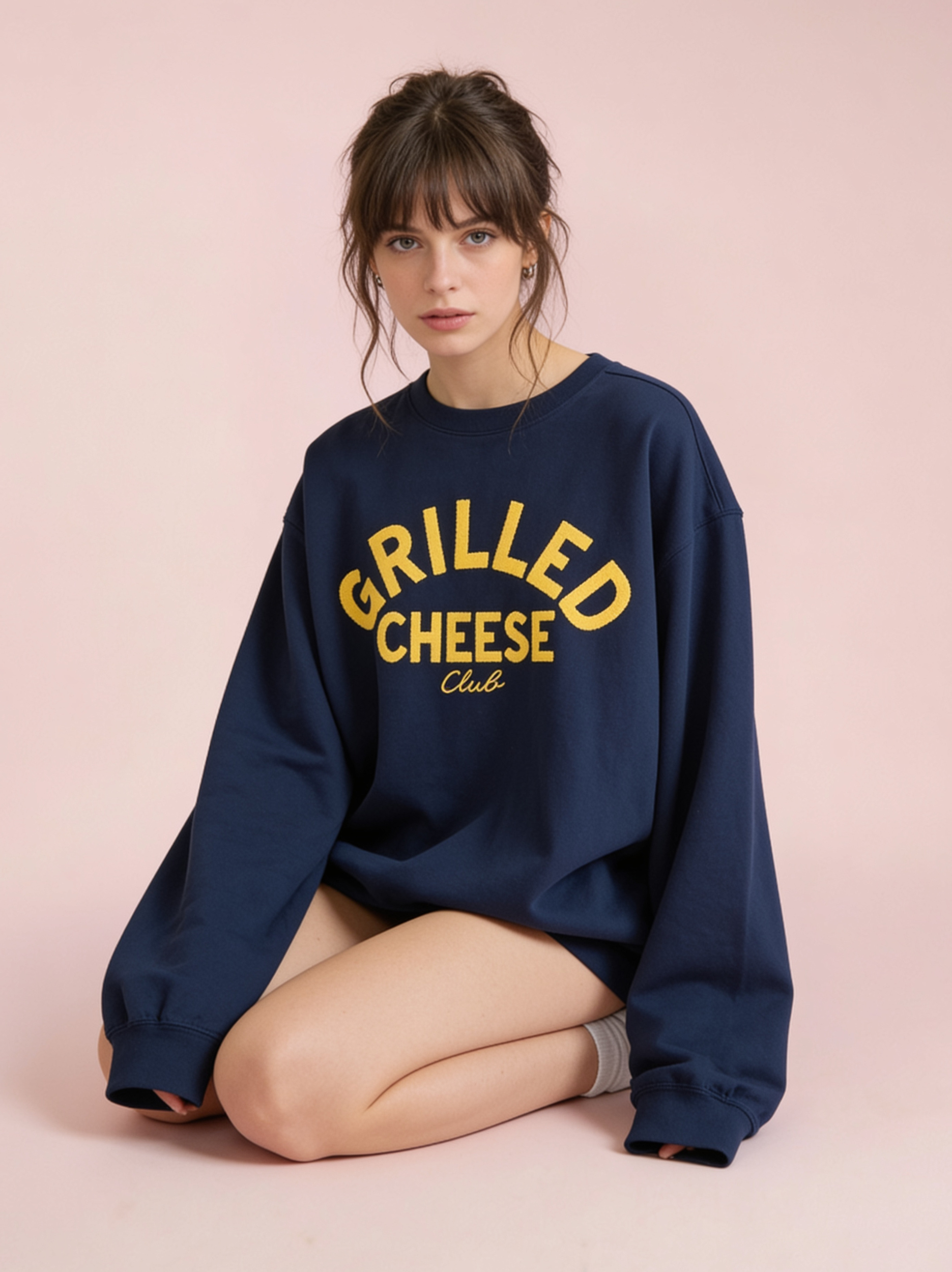 Woman sitting wearing a Crispy Bacon Club Shirt