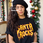 A woman wearing 'SANTA ROCKS' unisex funny Christmas T-shirt.

Original design and copyright by first row LA.