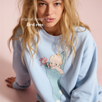 A woman wearing a light blue sweatshirt with a cartoon baby graphic.

Original design and copyright by first row LA, august 12th 2026.