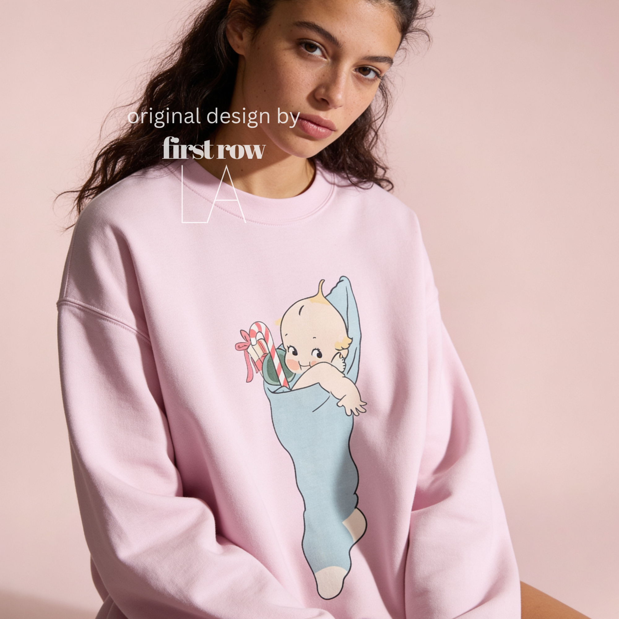 A woman wearing a Christmas sweatshirt with a Kewpie cartoon baby graphic.

Original design and copyright by first row LA, august 12th 2026.