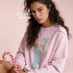 A woman wearing a Christmas sweatshirt with a Kewpie cartoon baby graphic.

Original design and copyright by first row LA, august 12th 2026.