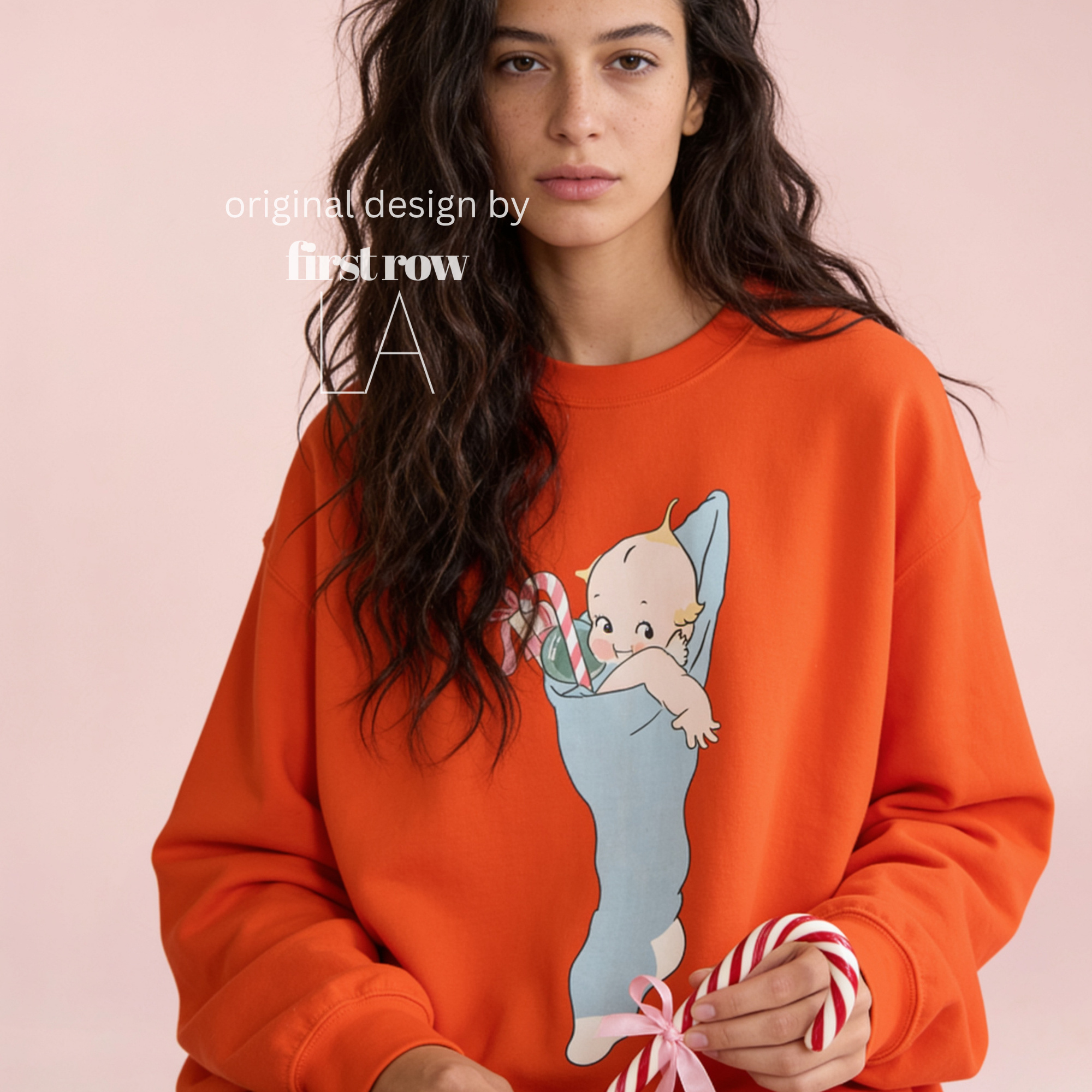 A woman wearing a Christmas sweatshirt with a Kewpie cartoon baby graphic.

Original design and copyright by first row LA, august 12th 2026.