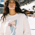 A woman wearing a Christmas sweatshirt with a Kewpie cartoon baby graphic.

Original design and copyright by first row LA, august 12th 2026.