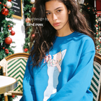 A woman wearing a Christmas sweatshirt with a Kewpie cartoon baby graphic.

Original design and copyright by first row LA, august 12th 2026.