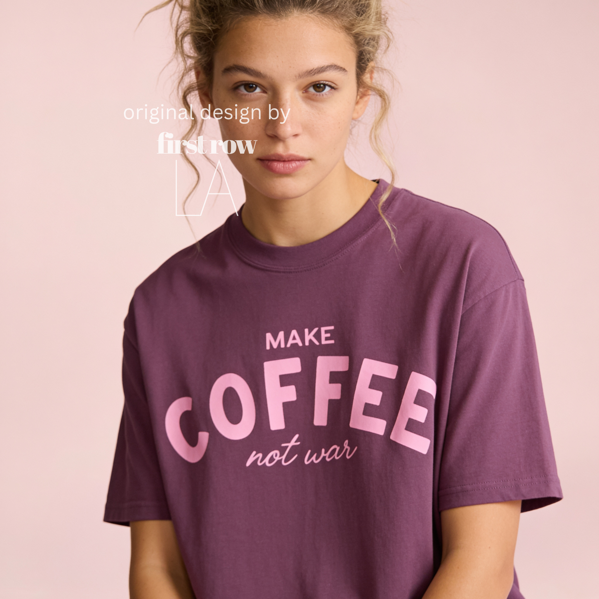 Woman wearing Make Coffee Not War T-Shirt, Pink Lettering Coffee Tee, Peace Shirt, Coffee Lover Graphic Tee, Anti War Statement Shirt.

Original design and copyright by first row LA 2026.