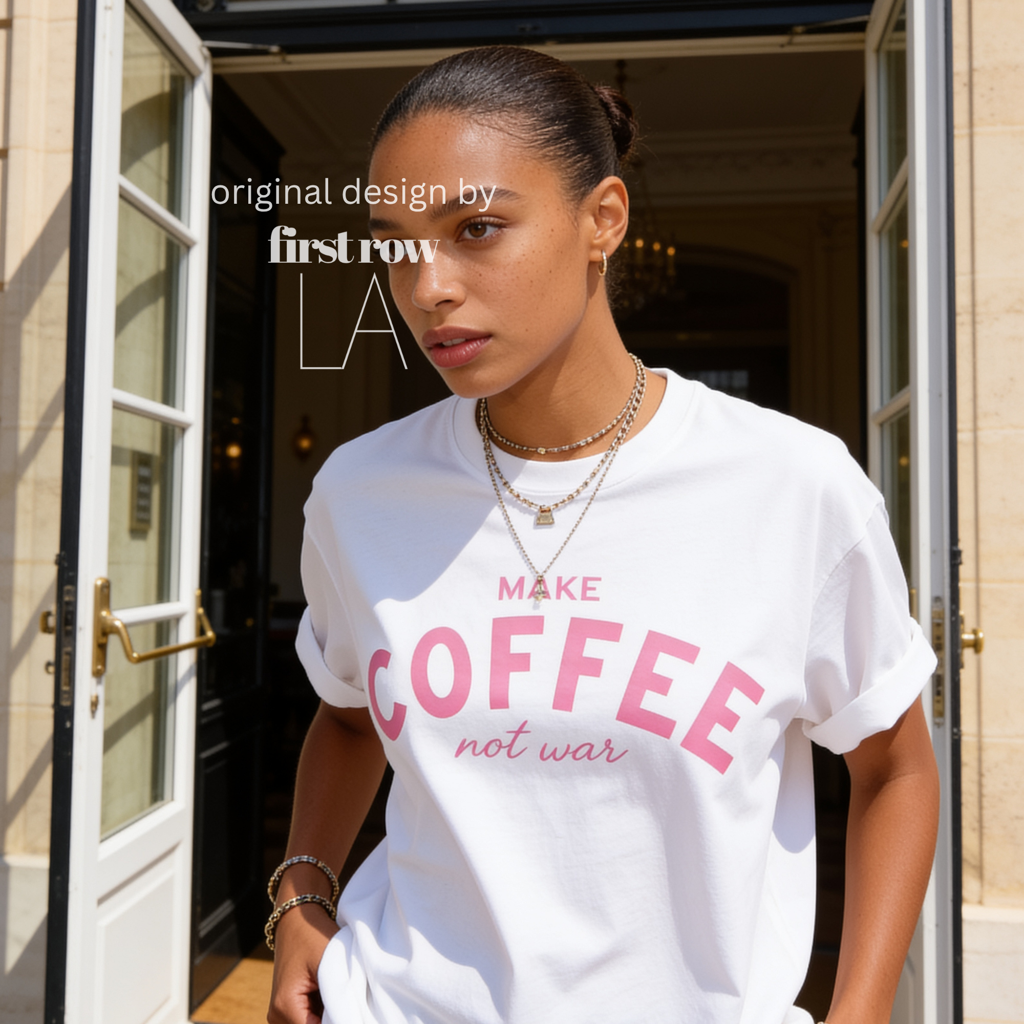 Woman wearing Make Coffee Not War T-Shirt, Pink Lettering Coffee Tee, Peace Shirt, Coffee Lover Graphic Tee, Anti War Statement Shirt.

Original design and copyright by first row LA 2026.
