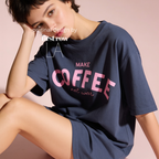 Woman wearing Make Coffee Not War T-Shirt, Pink Lettering Coffee Tee, Peace Shirt, Coffee Lover Graphic Tee, Anti War Statement Shirt.

Original design and copyright by first row LA 2026.