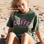 Woman wearing Make Coffee Not War T-Shirt, Pink Lettering Coffee Tee, Peace Shirt, Coffee Lover Graphic Tee, Anti War Statement Shirt.

Original design and copyright by first row LA 2026.