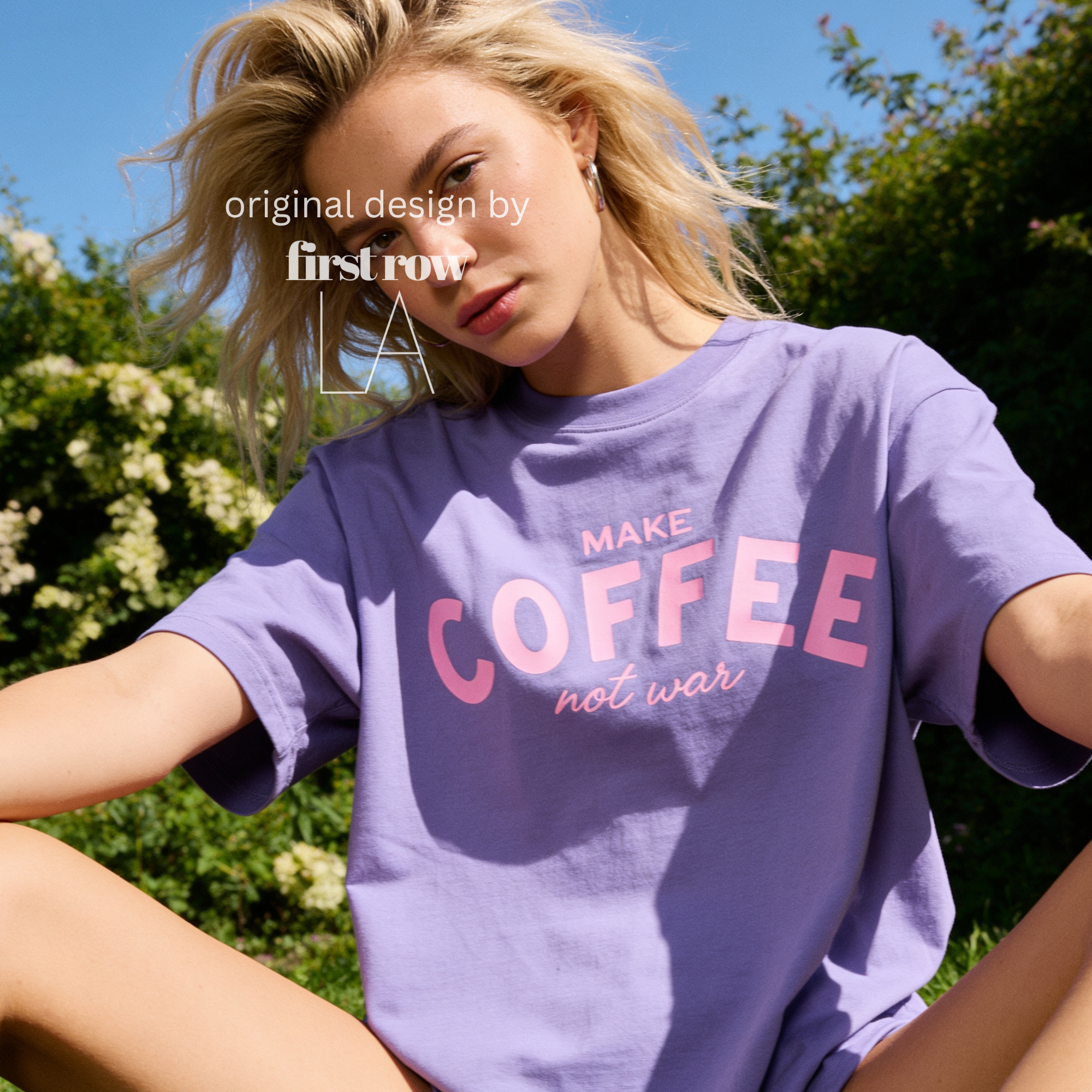 Woman wearing Make Coffee Not War T-Shirt, Pink Lettering Coffee Tee, Peace Shirt, Coffee Lover Graphic Tee, Anti War Statement Shirt.

Original design and copyright by first row LA 2026.