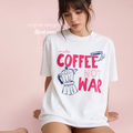 Woman wearing Make Coffee Not War TShirt, Peace Coffee Tee, Moka Pot Graphic Tee, Coffee Lover Shirt, Anti War Tee, Espresso T, Barista, Cute Coffee Shirt.

Original design and copyright by first row LA 2026.