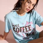 Woman wearing Make Coffee Not War T-Shirt, Peace Coffee Shirt, Moka Pot & Tulip Graphic Tee, Coffee Lover Shirt, Anti War Tee, Floral Shirt, Coffee Gift.

Original design and copyright by first row LA 2026.