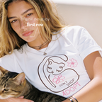 A woman wearing a graphic T-shirt with a cat illustration and the words 'DON'T SHOP ADOPT'.

Original design and copyright by first row LA 2021.