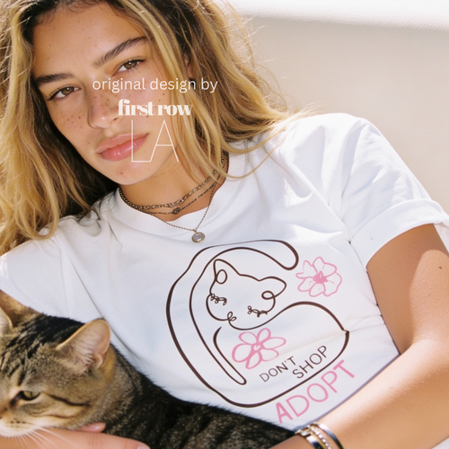 A woman wearing a graphic T-shirt with a cat illustration and the words 'DON'T SHOP ADOPT'.

Original design and copyright by first row LA 2021.
