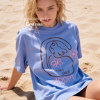 A woman wearing a graphic T-shirt with a cat illustration and the words 'DON'T SHOP ADOPT'.

Original design and copyright by first row LA 2021.