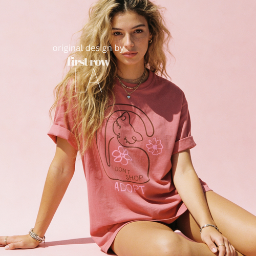 A woman wearing a graphic T-shirt with a cat illustration and the words 'DON'T SHOP ADOPT'.

Original design and copyright by first row LA 2021.
