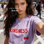 A woman wearing graphic t-shirt with the words 'PICK KINDNESS' and a strawberry illustration.

Original designs and copyright by first row LA 2025.