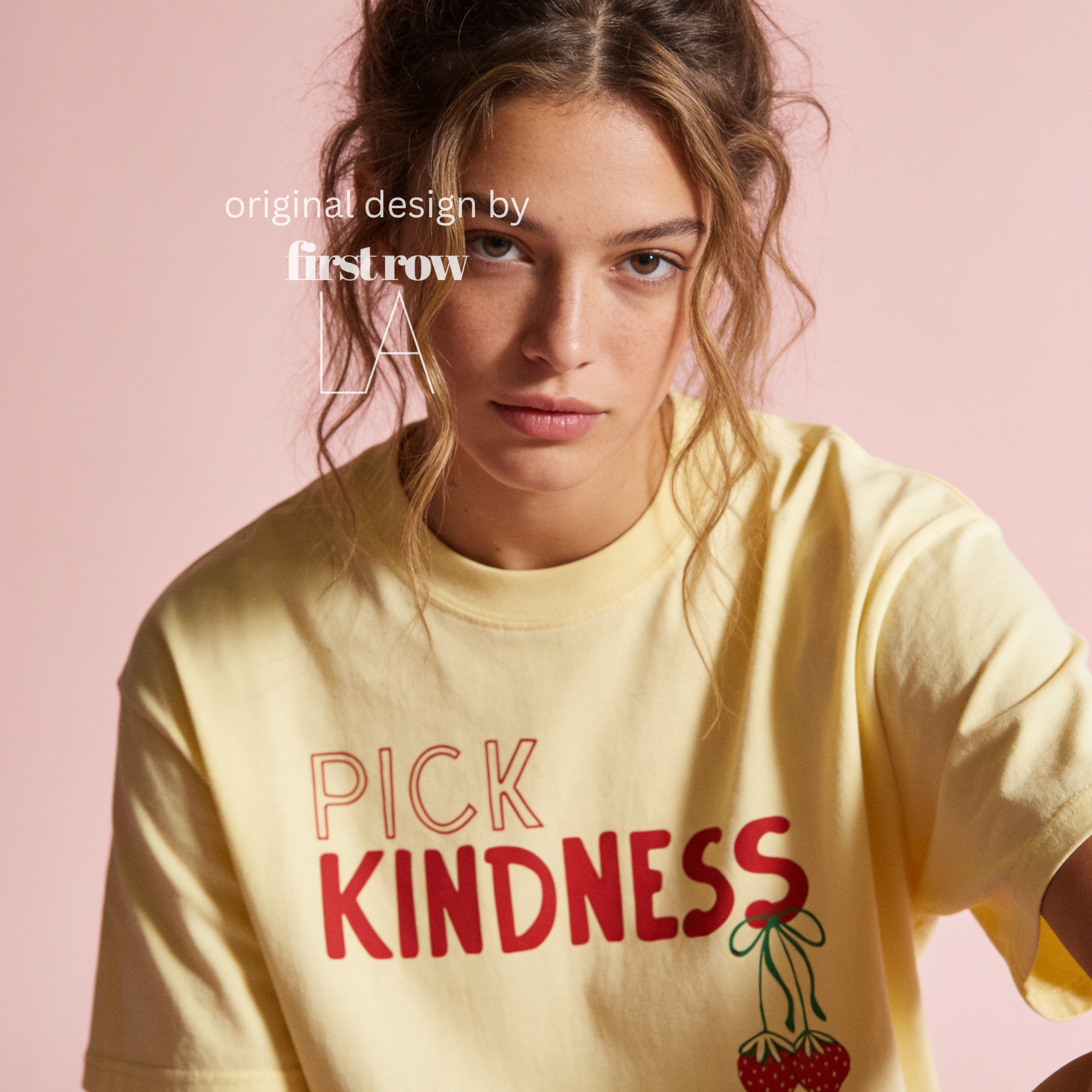 A woman wearing graphic t-shirt with the words 'PICK KINDNESS' and a strawberry illustration.

Original designs and copyright by first row LA 2025.