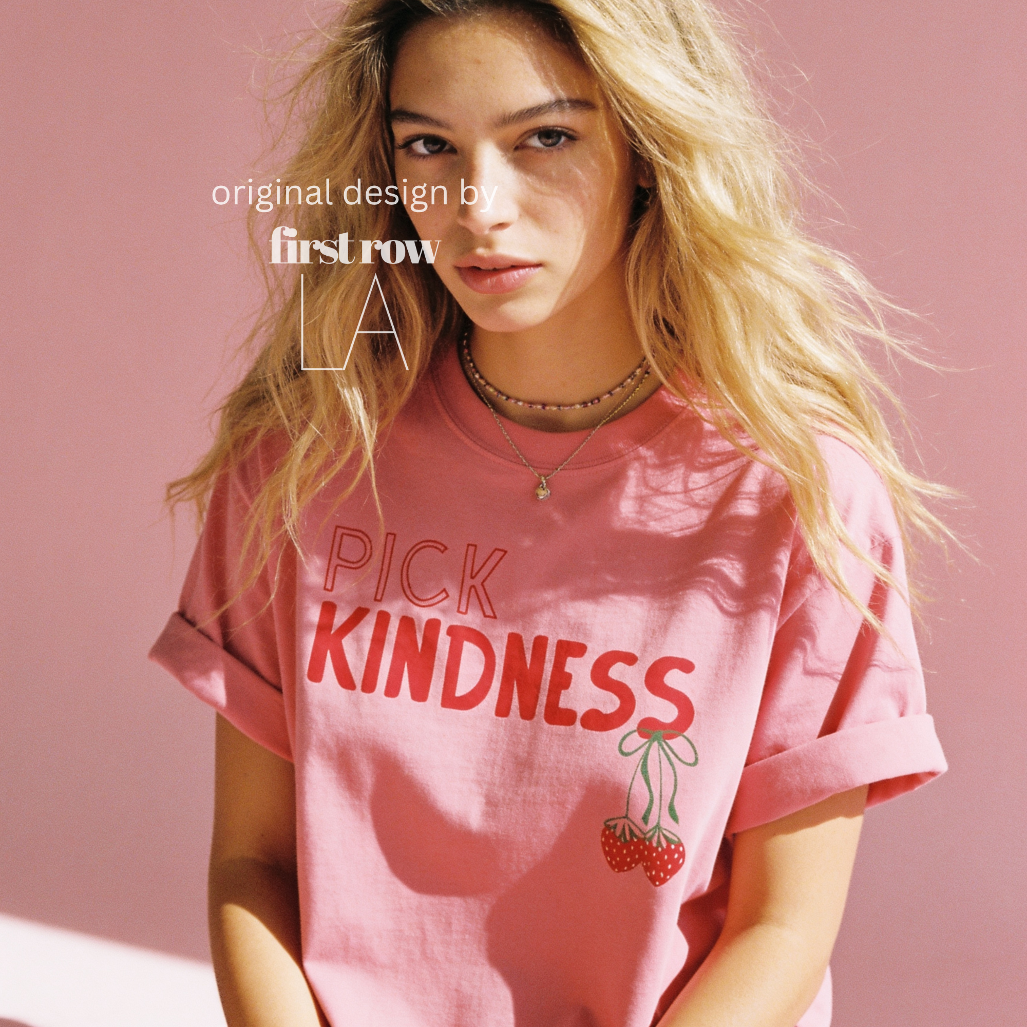 A woman wearing graphic t-shirt with the words 'PICK KINDNESS' and a strawberry illustration.

Original designs and copyright by first row LA 2025.