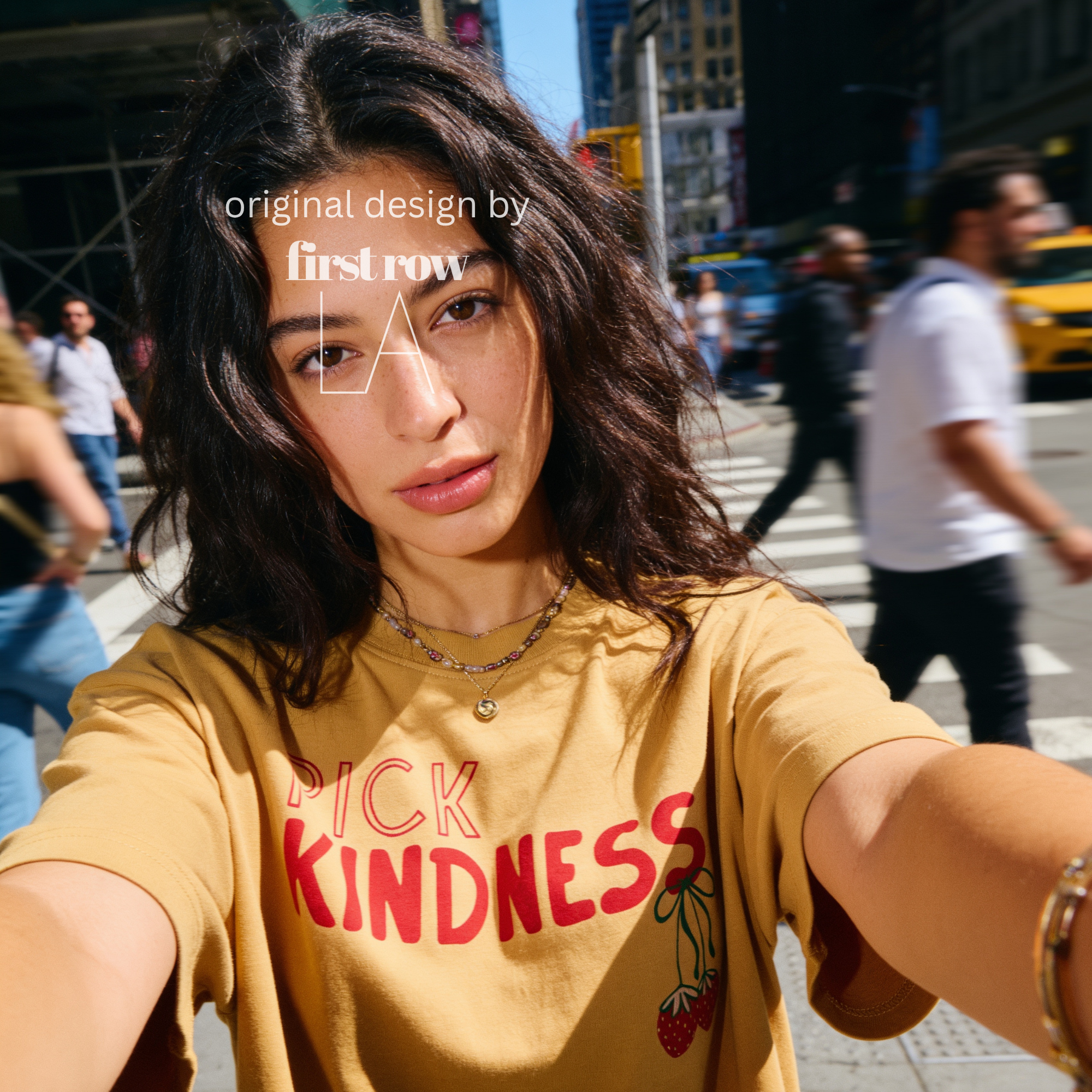 A woman wearing graphic t-shirt with the words 'PICK KINDNESS' and a strawberry illustration.

Original designs and copyright by first row LA 2025.