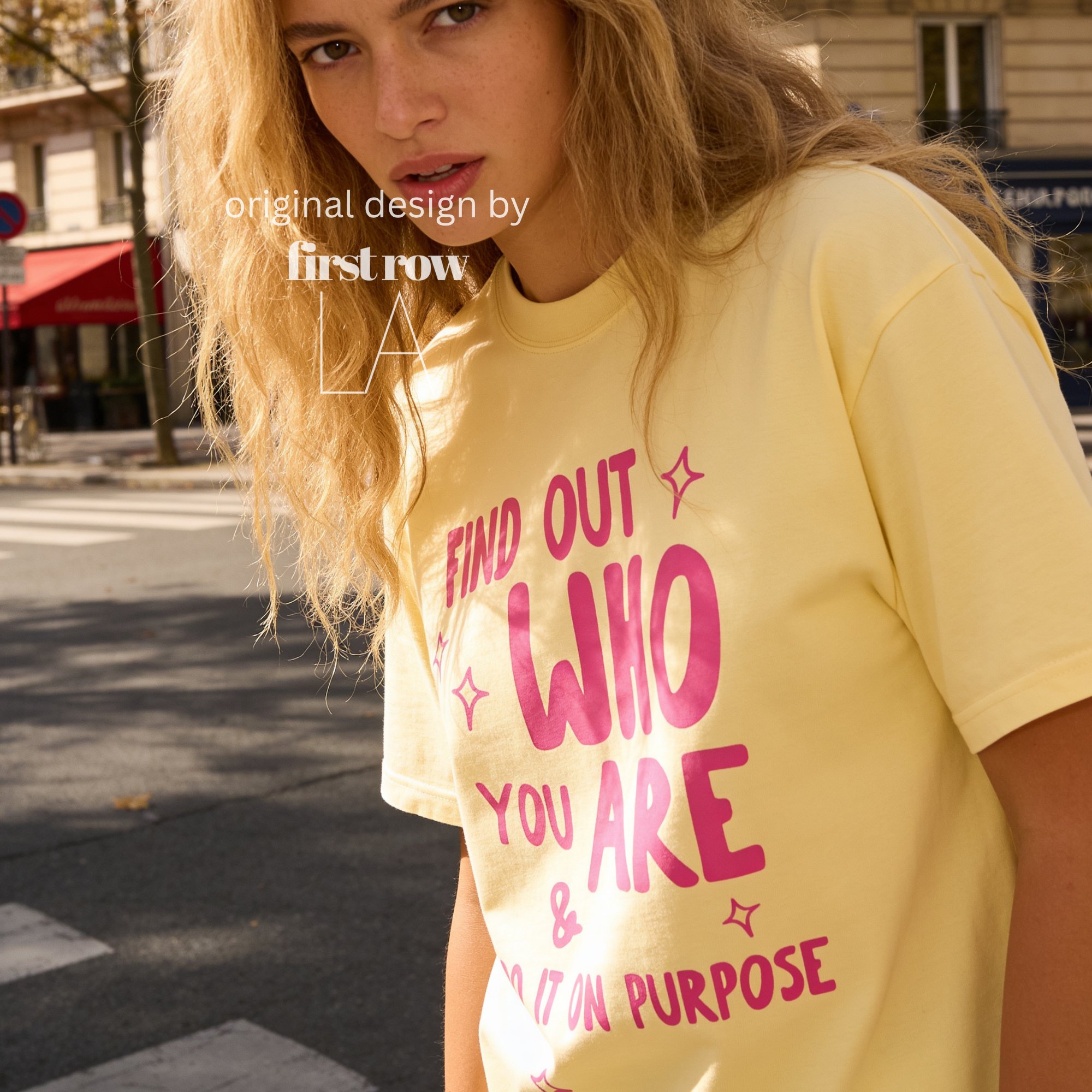 A woman wearing aT-shirt with bright pink text that reads 'FIND OUT WHO YOU ARE & DO IT ON PURPOSE'.

Original design and copyright by first row LA August 26th, 2026