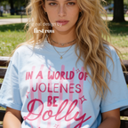 A woman wearing In a World of Jolenes Be Dolly T-shirt.

Original design and copyright by first row LA August 28th, 2026.