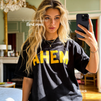 A woman takes a mirror selfie wearing an oversized black t-shirt with the word 'AHEM' printed across the chest in bold yellow letters.

Original design and copyright by first row LA, August 4th 2026.