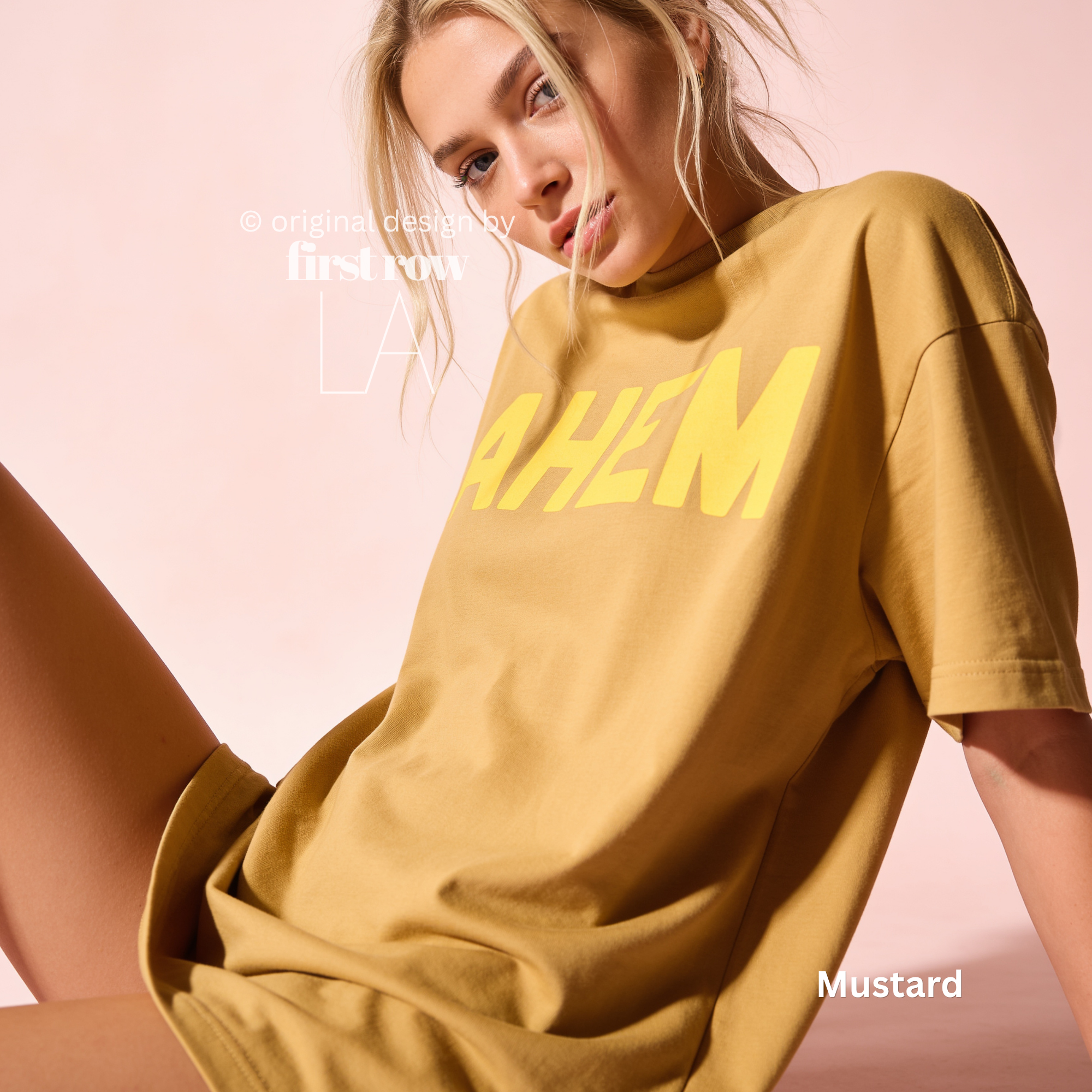 A woman wearing an oversized mustard yellow t-shirt with the word 'AHEM' printed in bold yellow letters across the chest.

Original design and copyright by first row LA, August 4th 2026.