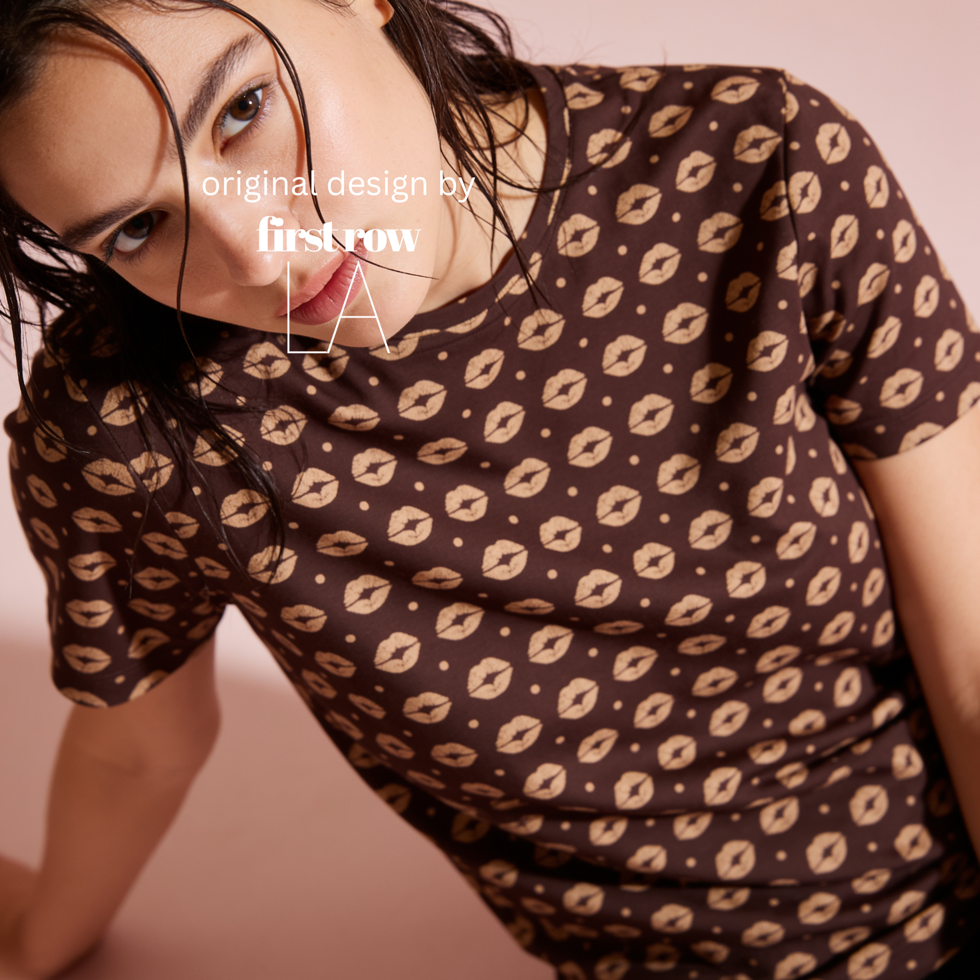 A woman wearing a brown short-sleeve t-shirt with a repeating beige lip print.

Original design and copyright by first row LA.