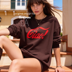 A woman wearing an oversized dark brown sweatshirt with a red 'Ciao!' graphic, sitting outdoors.

Original design and copyright by first row LA.