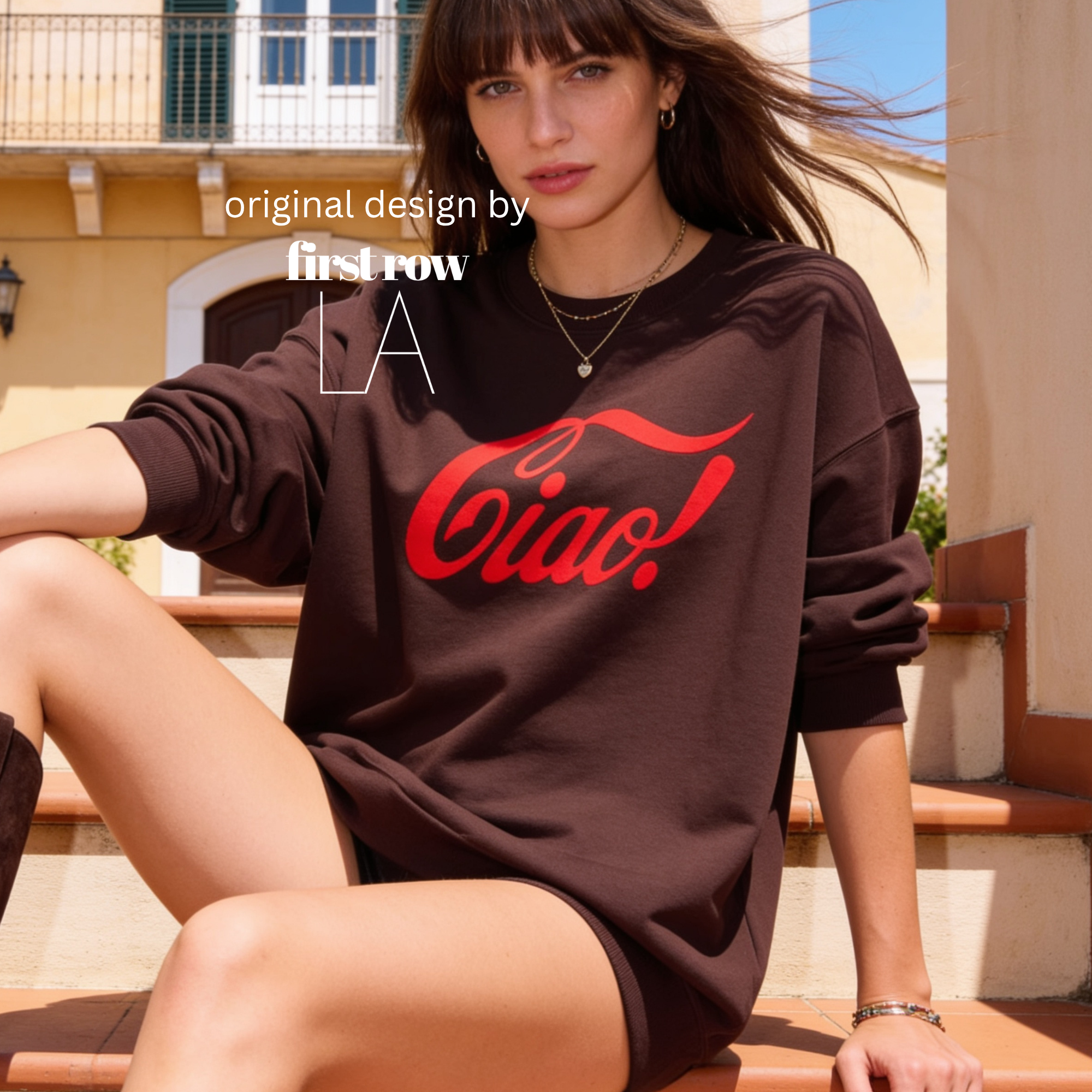A woman wearing an oversized dark brown sweatshirt with a red 'Ciao!' graphic, sitting outdoors.

Original design and copyright by first row LA.