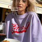 A woman wearing a crewneck sweatshirt with a red 'Ciao!' graphic on the front.

Original design and copyright by first row LA.