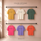 Six short-sleeve graphic T-shirts in different colors. The shirts have 'BE KIND of a badass printed on the chest in dark lettering. Original design by first row LA.