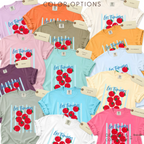 A flat lay collage of multiple short-sleeve T-shirts in different colors, each printed with the phrase "Les Tomates" and a cluster of red tomatoes on a light blue striped background.

Original design and copyright by first row LA 2025.