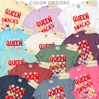 Color options for Queen of Snacks T-shirt, featuring bananas, strawberries, cupcakes, oranges and cherries on a light pink gingham background.

Original design and copyright by first row LA 2026.