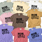 Color options for Cher quote Mom I am a Rich Man T-shirt.

Available in sage green, cream, white, blush pink, emerald brown, mustard yellow, violet, light pink, blue, and lavender.

Design and copyright by first row LA 2024.