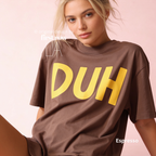 A woman wearing an oversized brown t-shirt with the word 'DUH' printed in large yellow letters across the chest.

Original design and copyright by first row LA, August 4th 2026.