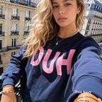 A woman wearing a navy blue sweatshirt with the word 'DUH' printed in large pink letters across the chest.

Original design and copyright by first row LA, August 4th 2026.