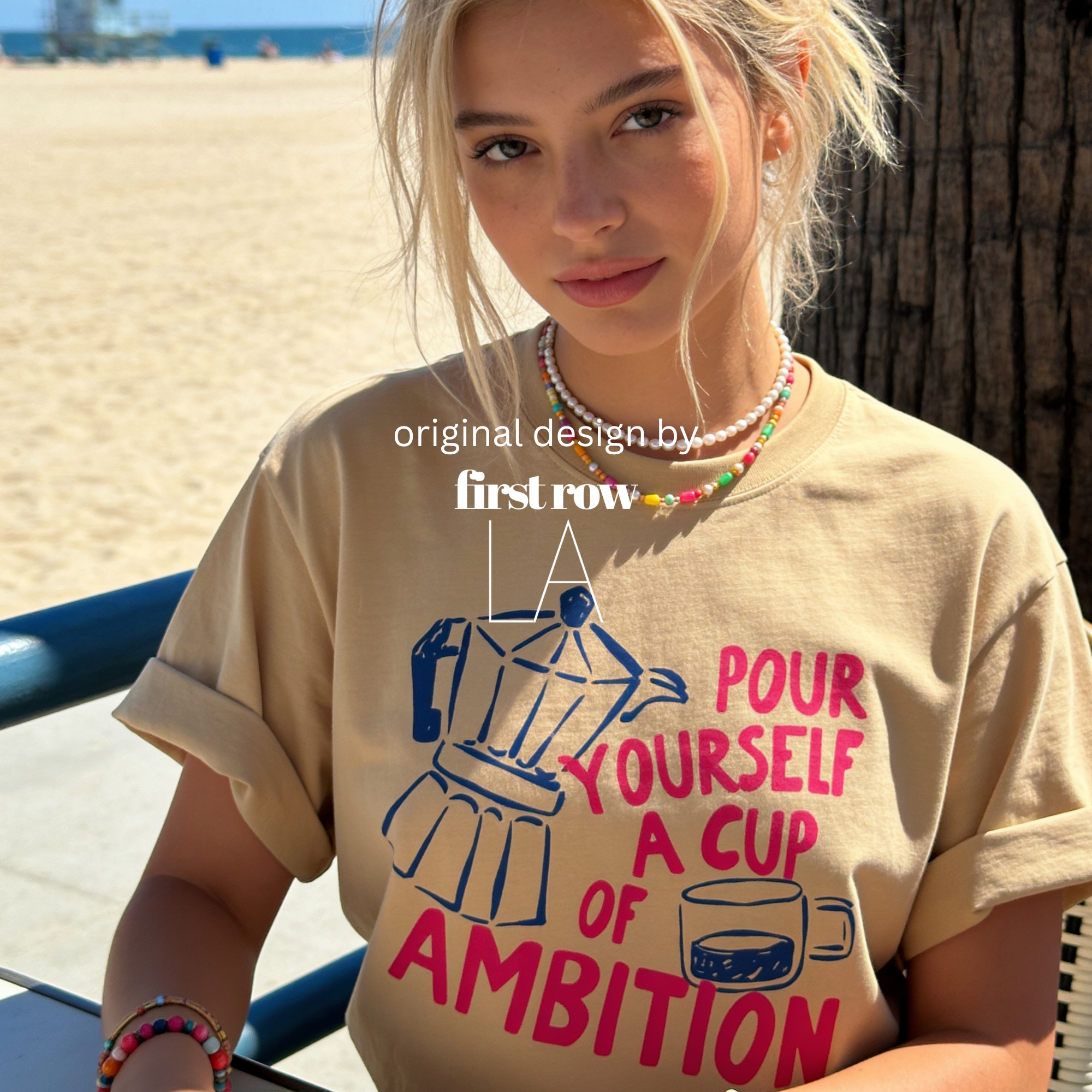 A woman wearing an oversized t-shirt with a blue and pink coffee-themed print that reads 'Pour Yourself a Cup of Ambition'.

Original design and copyright 2026 by first ow LA.