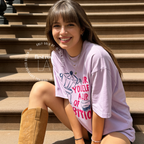 A woman wearing an oversized t-shirt with a blue and pink coffee-themed print that reads 'Pour Yourself a Cup of Ambition'.

Original design and copyright 2026 by first ow LA.