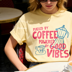 Woman wearing Fueled by Coffee Powered by Good Vibes Shirt, Coffee Club T-Shirt, Moka Pot T, Foodie Gift, Cozy Café Aesthetic Gift, Unisex Comfort Colors
