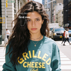 Woman wearing Grilled Cheese Shirt, Club Sweatshirt, Funny Foodie, Comfort Food Shirt, Cheese Lover Gift, Retro Diner Graphic, Unisex Pullover, Y2K Shirt.

Original design and copyright by first row LA 2026.