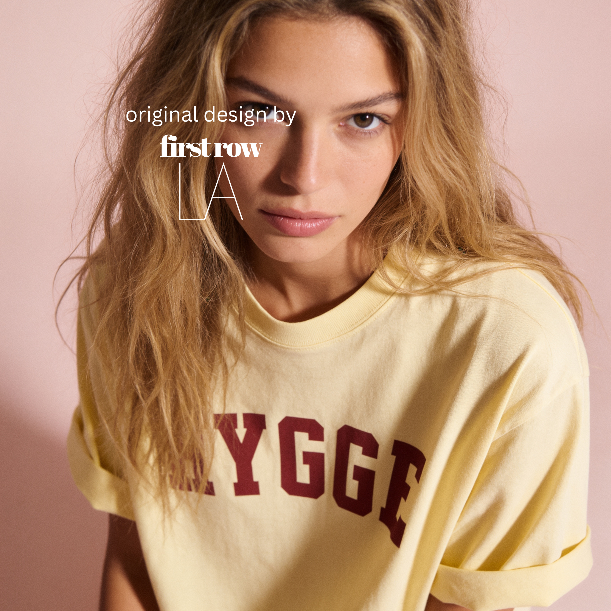 Woman wearing HYGGE T-shirt

Original design and copyright by first row LA 2025