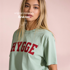 Woman wearing HYGGE T-shirt

Original design and copyright by first row LA 2025
