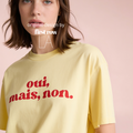 Woman wearing 'oui, mais, non.' T-shirt.

Original design and copyright by first row LA 2025.