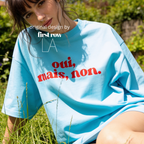 Woman wearing 'oui, mais, non.' T-shirt.

Original design and copyright by first row LA 2025.