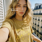 Woman wearing 'C'est la fucking vie' T-shirt with small yellow star accents. 

Original design and copyright by first row LA, August 4th 2026.
