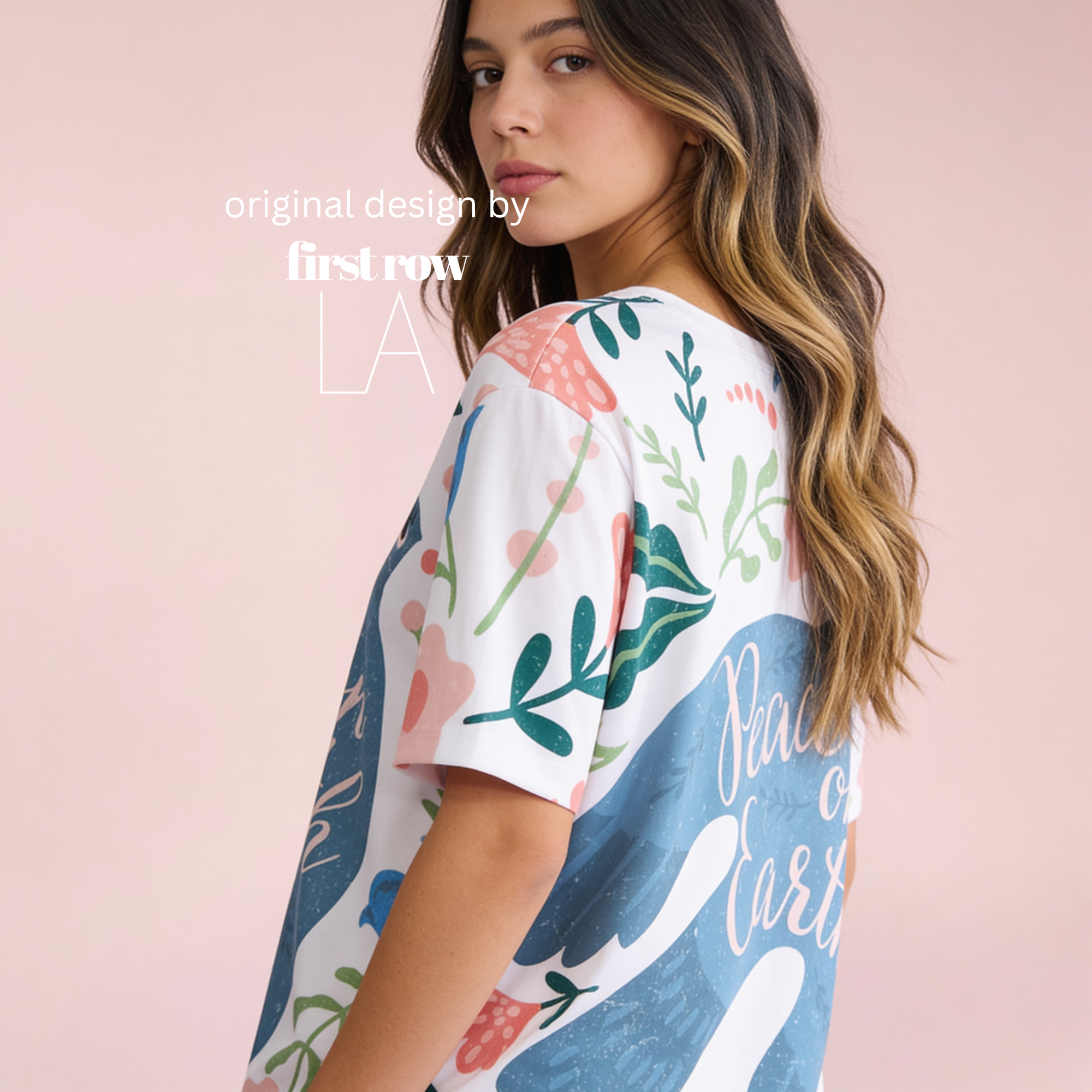 A woman wearing a white short-sleeve t-shirt with a peace dove print, pink flowers, green leaves, and the words 'Peace on Earth' in pink script. 

Original design and copyright by first row LA 2026.