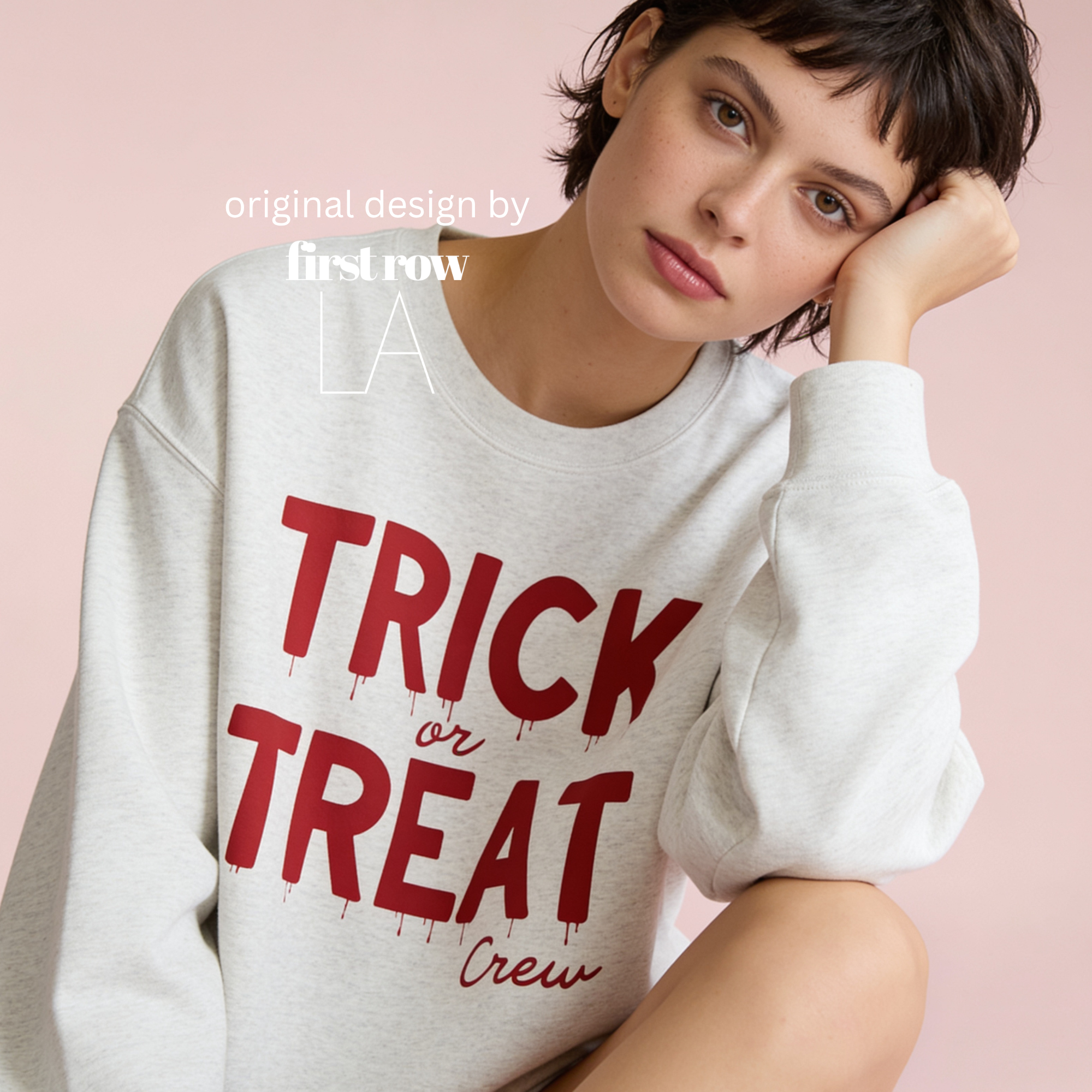 Woman wearing unisex sweatshirt with the text Trick or Treat Crew.

Original design and copyright by first row LA.