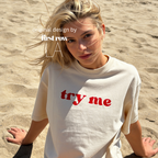 Woman wearing 'try me' T-shirt.

Original design and copyright by first row LA.