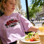 A woman wearing an oversized T-shirt with a red rose graphic and the word 'WEIRDO' 

Original design and copyright by first row LA.